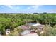 Waterfront home surrounded by lush greenery and beautiful landscaping, featuring a screened pool at 3400 Allapatchee Dr, Punta Gorda, FL 33950
