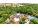 Aerial shot of a home with waterfront access, featuring a large driveway and landscaping at 3400 Allapatchee Dr, Punta Gorda, FL 33950