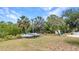 Backyard featuring lush greenery, mature trees, and ample open space, ideal for outdoor activities and relaxation at 3400 Allapatchee Dr, Punta Gorda, FL 33950