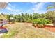Lush backyard featuring tropical landscaping, beautiful canal views and a well maintained lawn at 3400 Allapatchee Dr, Punta Gorda, FL 33950