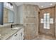 Bathroom features tile flooring, granite counter, and tiled shower with a glass block window at 3400 Allapatchee Dr, Punta Gorda, FL 33950