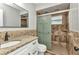 Bathroom with a granite vanity, framed mirror, and a glass enclosed shower at 3400 Allapatchee Dr, Punta Gorda, FL 33950