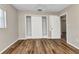 Bedroom featuring hardwood floors, a closet, and an entry door with white trim at 3400 Allapatchee Dr, Punta Gorda, FL 33950