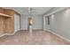 Spacious bedroom features neutral paint, tile flooring, ceiling fan, and a hallway entry at 3400 Allapatchee Dr, Punta Gorda, FL 33950