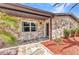 Close up of stone-faced entrance with decorative stone pathway at 3400 Allapatchee Dr, Punta Gorda, FL 33950
