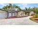 Exterior of home with stone facade, well maintained yard, and a spacious driveway at 3400 Allapatchee Dr, Punta Gorda, FL 33950
