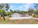 Exterior of home with stone facade, well maintained yard, spacious driveway, and 2 car garage at 3400 Allapatchee Dr, Punta Gorda, FL 33950