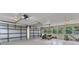 Spacious three-car garage with ample lighting, several windows, and epoxy flooring at 3400 Allapatchee Dr, Punta Gorda, FL 33950