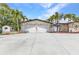 Home featuring a two-car garage and meticulous landscaping, offers both curb appeal and functionality at 3400 Allapatchee Dr, Punta Gorda, FL 33950