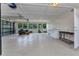 Spacious three-car garage with ample lighting, several windows, and epoxy flooring at 3400 Allapatchee Dr, Punta Gorda, FL 33950