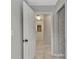 Hallway leading to the back door with tile flooring and a sliding door closet at 3400 Allapatchee Dr, Punta Gorda, FL 33950