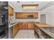 Kitchen showcasing wooden cabinetry, stainless steel appliances, and granite countertops at 3400 Allapatchee Dr, Punta Gorda, FL 33950