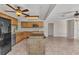 Open kitchen layout with wooden cabinets, an island, stainless steel appliances, and tile flooring at 3400 Allapatchee Dr, Punta Gorda, FL 33950