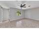 Spacious living room with tile flooring, a ceiling fan, and a window providing views of the yard at 3400 Allapatchee Dr, Punta Gorda, FL 33950