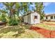 Outbuilding in the backyard with a wooden swing and manicured landscaping, adds charm and functionality at 3400 Allapatchee Dr, Punta Gorda, FL 33950