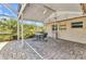 Inviting screened patio with ceiling fan, outdoor seating, and beautiful views of the lush backyard at 3400 Allapatchee Dr, Punta Gorda, FL 33950