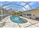 Enclosed screened pool in backyard with brick pavers at 3400 Allapatchee Dr, Punta Gorda, FL 33950