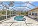 Beautiful screened pool with brick pavers and outdoor seating areas surrounded by lush landscaping at 3400 Allapatchee Dr, Punta Gorda, FL 33950