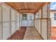 Cozy porch with wood ceiling, lattice walls, and a wooden pathway to the entry door at 3400 Allapatchee Dr, Punta Gorda, FL 33950