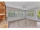 Bright sun room with tile floors, built-in storage, and multiple windows offering natural light at 3400 Allapatchee Dr, Punta Gorda, FL 33950