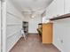 Cozy workshop with built in workbench, white cabinets, carpet, and ceiling fan at 3400 Allapatchee Dr, Punta Gorda, FL 33950