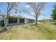 Large backyard with mature trees and a chain link fence at 3515 Vasco St, Punta Gorda, FL 33950