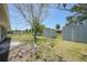 Fenced backyard featuring mature trees, storage sheds, and ample green space at 3515 Vasco St, Punta Gorda, FL 33950