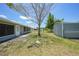 Fenced backyard with mature trees and exterior storage sheds at 3515 Vasco St, Punta Gorda, FL 33950