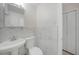 Updated bathroom features modern fixtures, marble-look tile, and ample lighting with a minimalist design at 3515 Vasco St, Punta Gorda, FL 33950