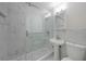A modern bathroom boasts tiled walls, glass shower doors, updated fixtures, and a shuttered window at 3515 Vasco St, Punta Gorda, FL 33950