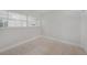 A well-lit bedroom with tile floors and a large window provides an airy, minimalist space at 3515 Vasco St, Punta Gorda, FL 33950