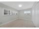 A bright bedroom is well lit by two shuttered windows with neutral walls, tile flooring, and closet space at 3515 Vasco St, Punta Gorda, FL 33950