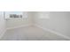 A clean, empty bedroom is brightly lit by shuttered windows, revealing tile floors at 3515 Vasco St, Punta Gorda, FL 33950