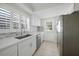 Well-lit kitchen with stainless steel appliances, white cabinets, and modern backsplash at 3515 Vasco St, Punta Gorda, FL 33950