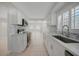 Modern kitchen featuring sleek appliances, white cabinets, and an open layout at 3515 Vasco St, Punta Gorda, FL 33950