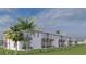 Townhome complex exterior showcasing back patios, second-story balconies, and lush green landscaping at 3609 Bal Harbor Blvd, Punta Gorda, FL 33950