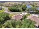 A lovely aerial view of the property showcasing lush greenery and a picturesque pond in a desirable community at 4098 Fairway Pl, North Port, FL 34287