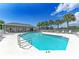 Community pool, showcasing its crystal-clear water, ample seating, and a covered area for shade and relaxation at 4098 Fairway Pl, North Port, FL 34287