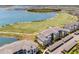 Aerial view of lakeside condo complex with golf course, lake, and covered parking at 43050 Greenway Blvd # 645, Punta Gorda, FL 33982