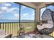 Enjoy the screened balcony with lake views, a hanging chair, and space for relaxation at 43050 Greenway Blvd # 645, Punta Gorda, FL 33982