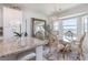 Dining room with chandelier, stylish chairs, and a view of the water at 43050 Greenway Blvd # 645, Punta Gorda, FL 33982