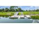 Picturesque floating dock and kayak launch on a serene pond under a bright sky at 43050 Greenway Blvd # 645, Punta Gorda, FL 33982