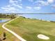 Scenic golf course view with a pristine green, sand trap, and a smooth cart path at 43050 Greenway Blvd # 645, Punta Gorda, FL 33982