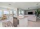 Open concept kitchen with granite countertops, island seating, and stainless steel dishwasher opens to living area at 43050 Greenway Blvd # 645, Punta Gorda, FL 33982