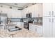 Bright kitchen features white cabinets, granite countertops, stainless steel appliances, and stylish backsplash at 43050 Greenway Blvd # 645, Punta Gorda, FL 33982