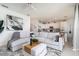 Open-concept living area with kitchen view, featuring a large sectional sofa and modern decor at 43050 Greenway Blvd # 645, Punta Gorda, FL 33982