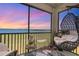 Relaxing patio with comfortable seating and stunning views of the golf course and colorful evening sky at 43050 Greenway Blvd # 645, Punta Gorda, FL 33982