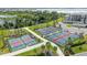 Several pickleball courts with tennis nets near walking path and beautiful, lush landscaping at 43050 Greenway Blvd # 645, Punta Gorda, FL 33982