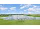 Scenic view of a pond and golf course with lush landscaping and community buildings at 43050 Greenway Blvd # 645, Punta Gorda, FL 33982