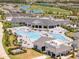 Aerial view of the community pool and clubhouse surrounded by lush landscaping at 43050 Greenway Blvd # 645, Punta Gorda, FL 33982